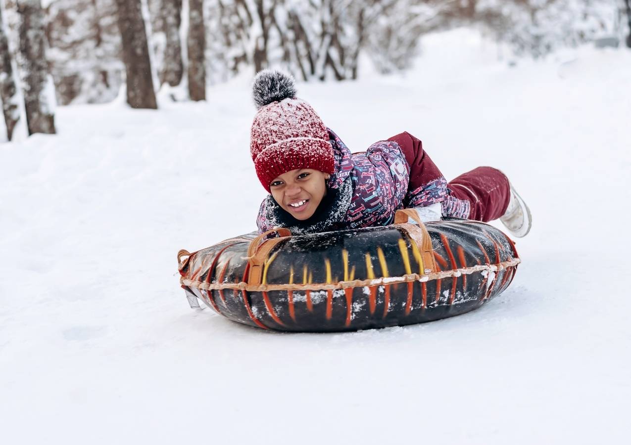 girl having fun in snow tubing