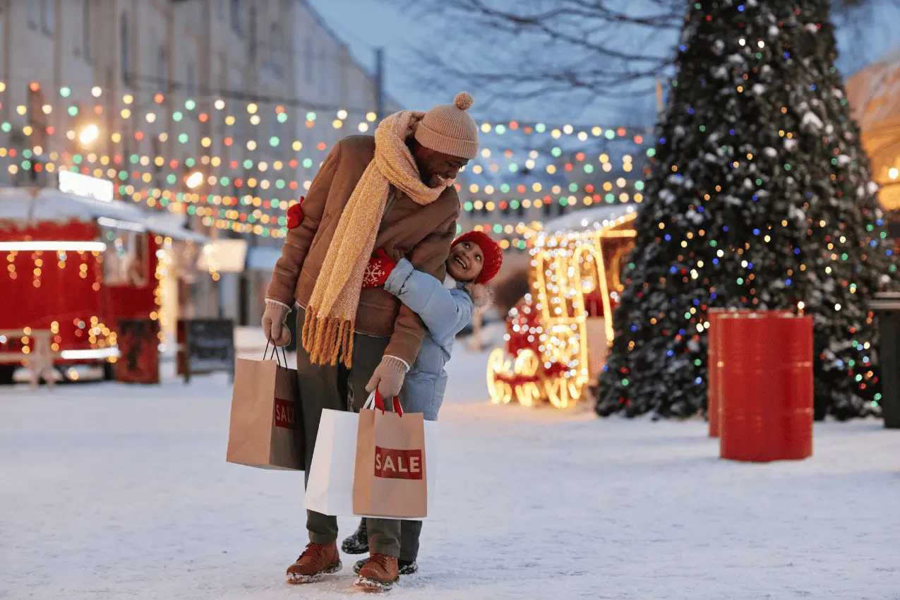 happy girl with father in winter christmas enjoying shopping