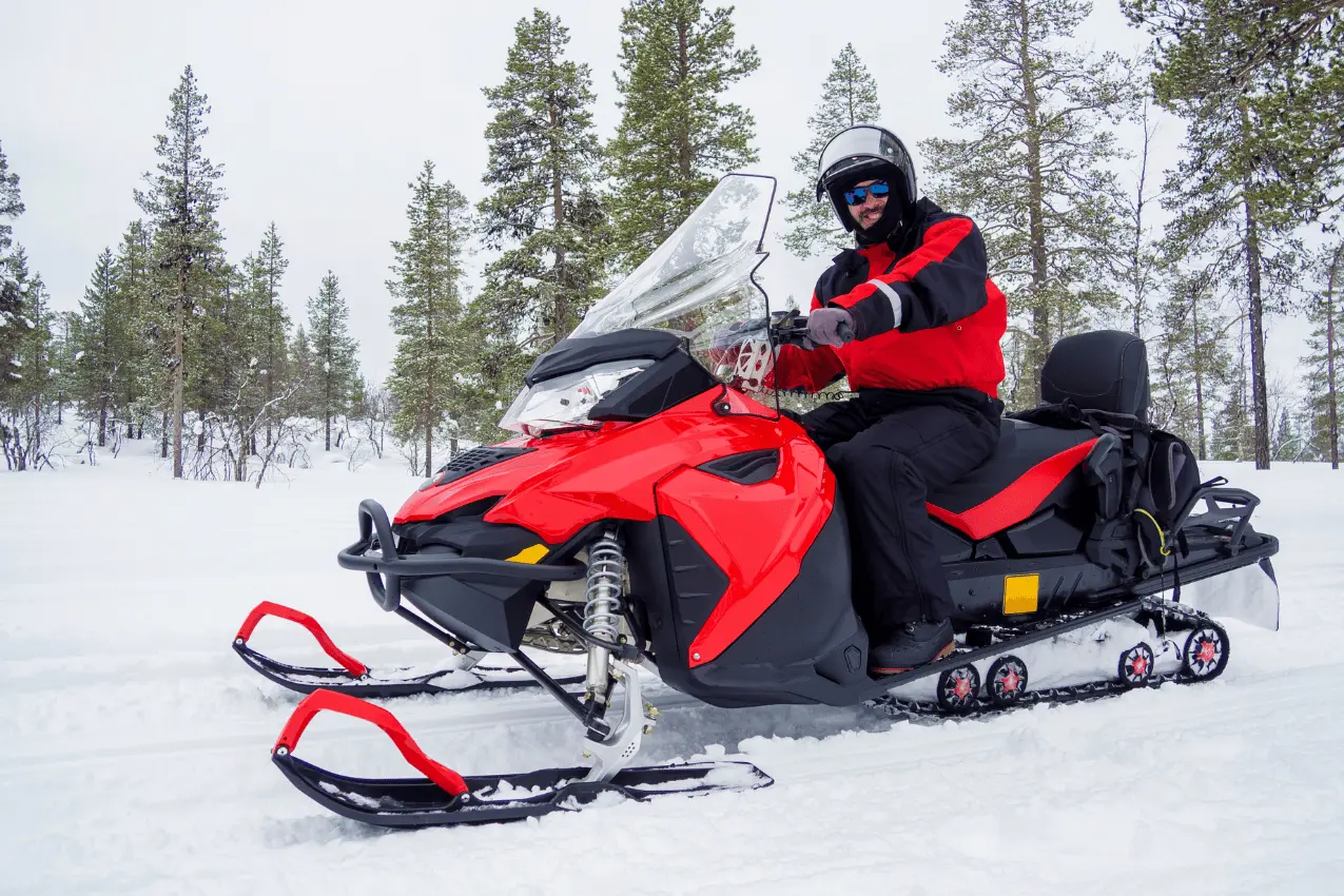 man with red quad bike on snowy poconos mountain