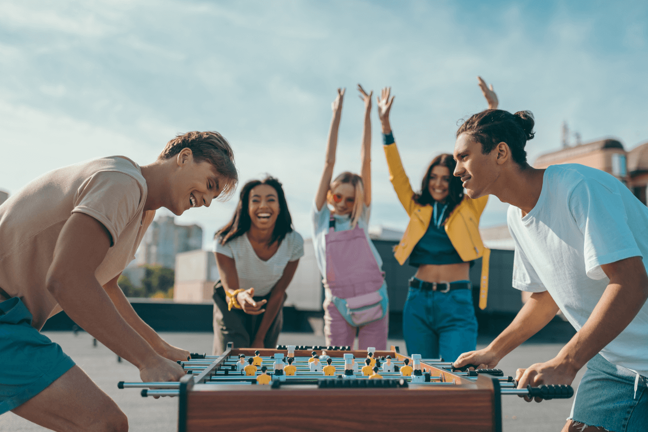 group of happy young-friends playing outdoor game