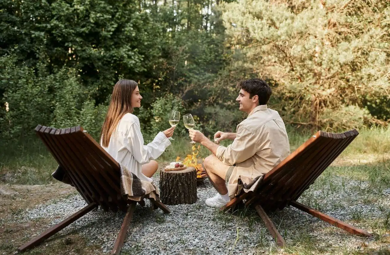 Romantic couple holding wine and grinning